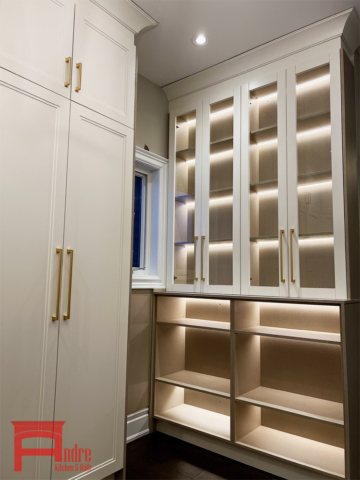 Transitional Walk In Closet With Painted Mdf Doors, Beige Linen Interior, And Display Case With Led Lighting